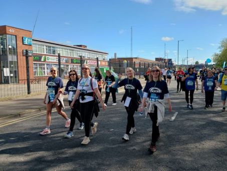 A photo of women wearing ASCERT t-shirts and walking in the Belfast Marathon 8 Mile Walk.
