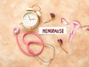 A clock, uterus and sign saying menopause.
